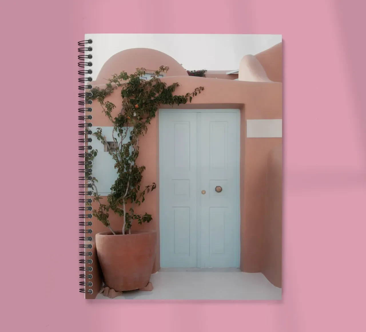 Terracotta building with blue door - Santorini, Greece spiral notebook by Kimberley Jekel Photography