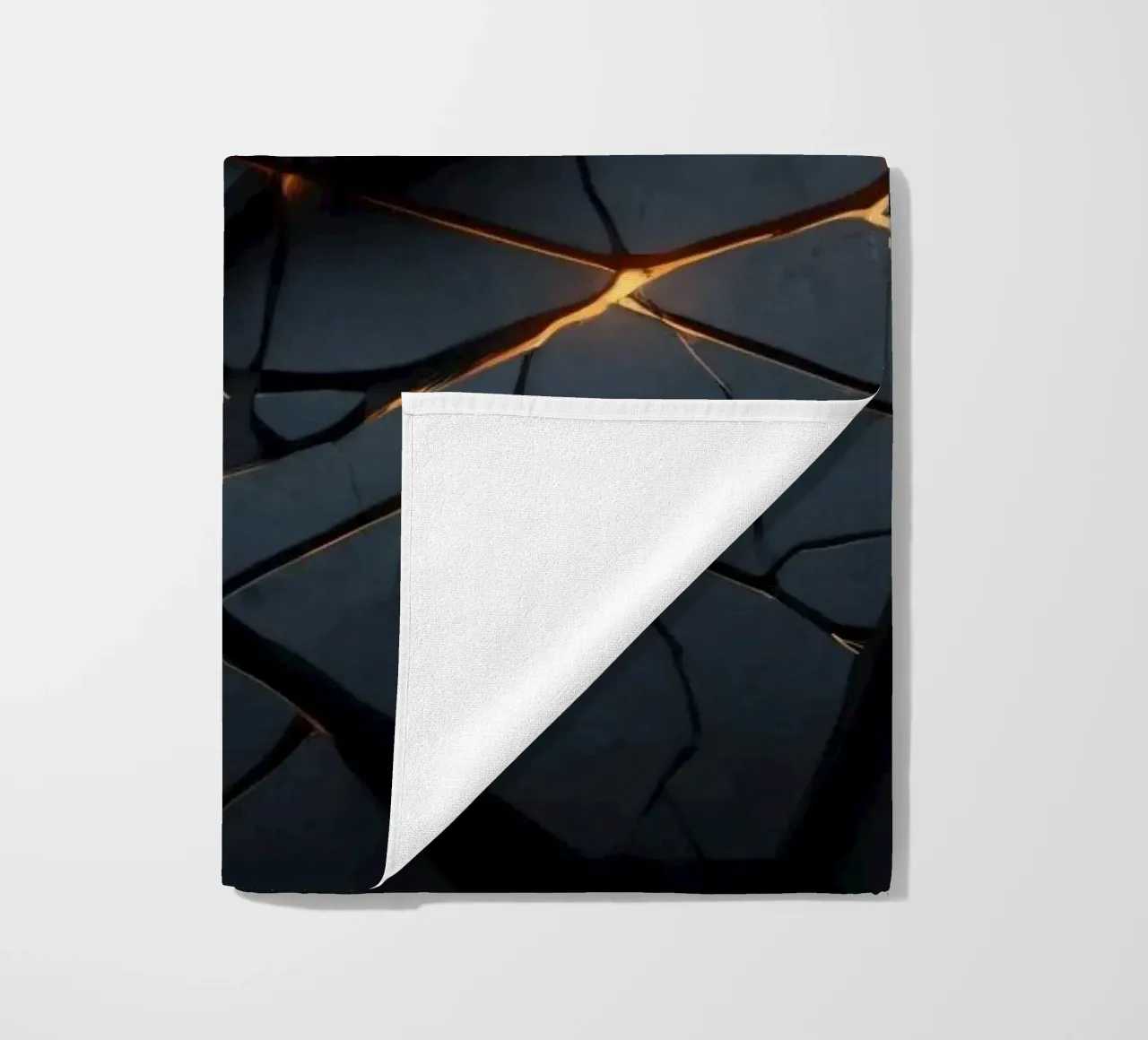 cracks in a dark surface create an intriguing abstract back beach towel by DesignDoodle