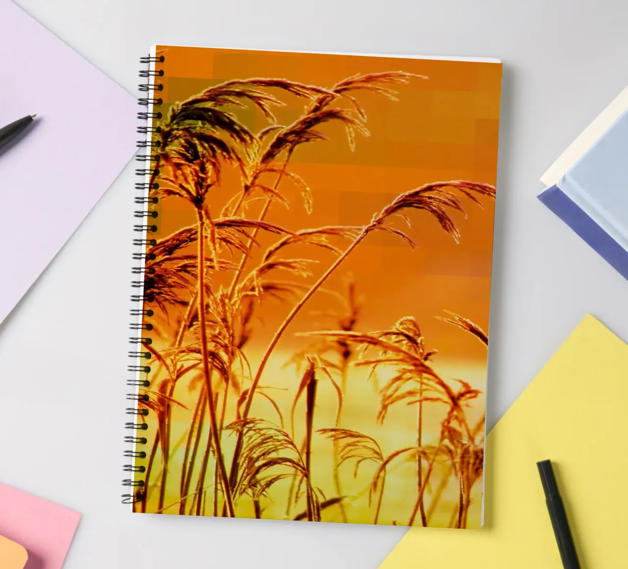 Golden reeds against an orange rectangular background spiral notebook by Something for you