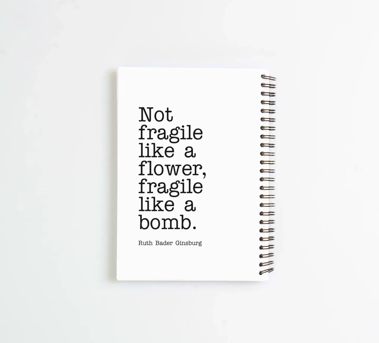 Not fragile like a flower, fragile like a bomb quote spiral notebook by Paigaam Studio