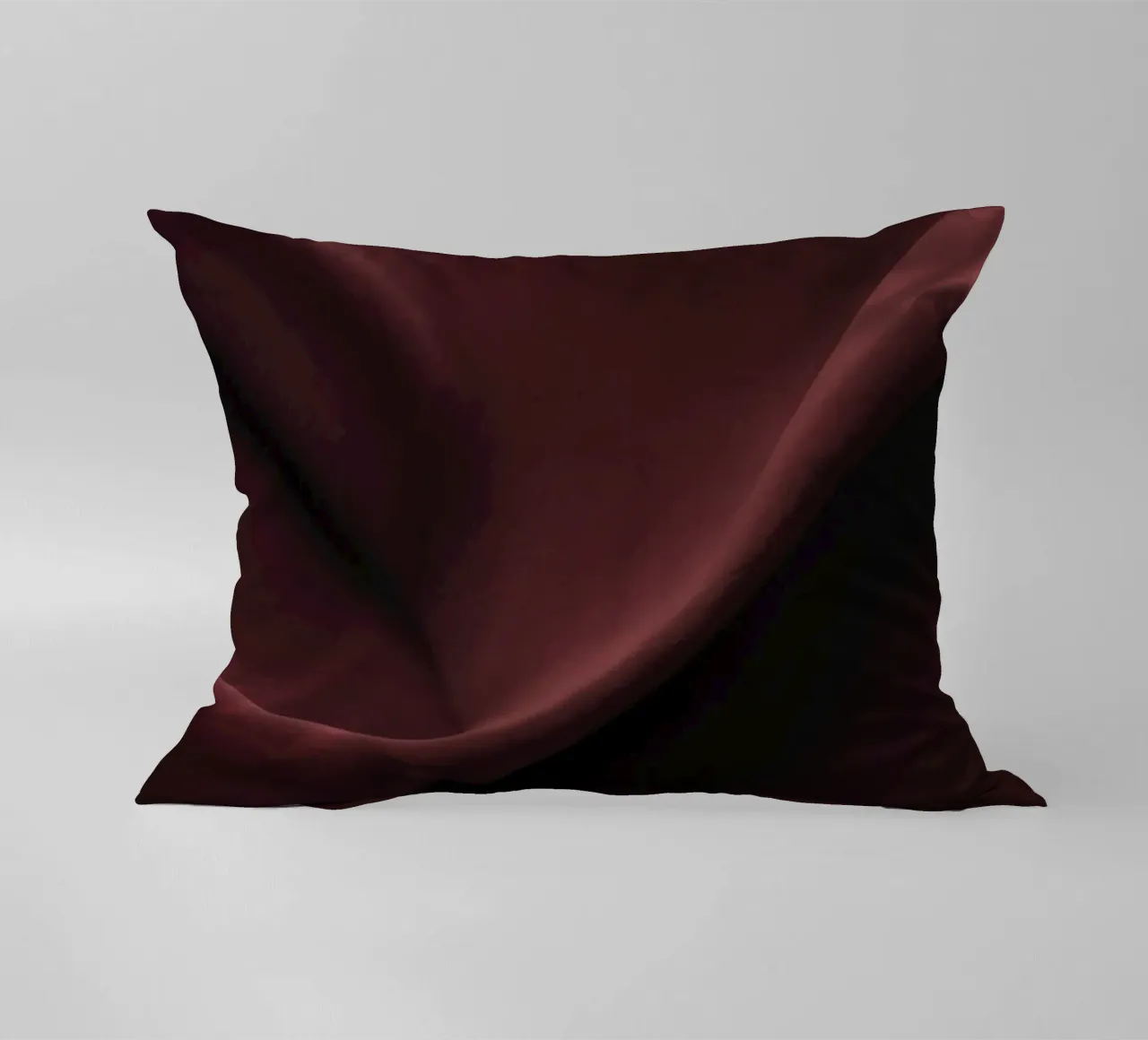 Elegant abstract background featuring smooth, flowing maroon decorative cushion by DesignDoodle