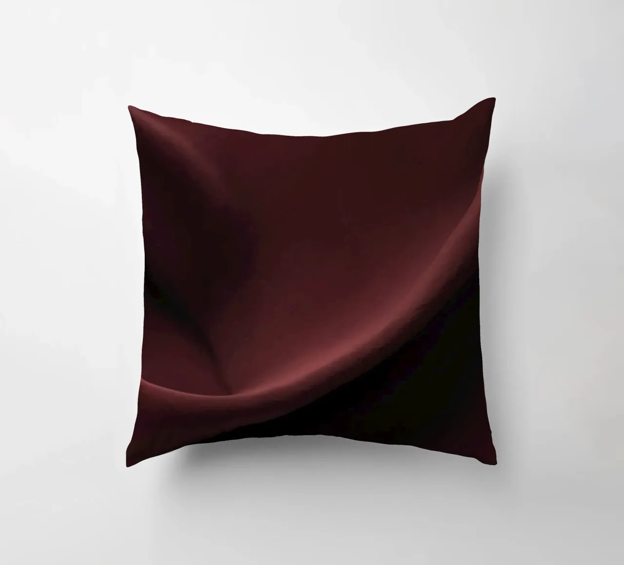Elegant abstract background featuring smooth, flowing maroon decorative cushion by DesignDoodle