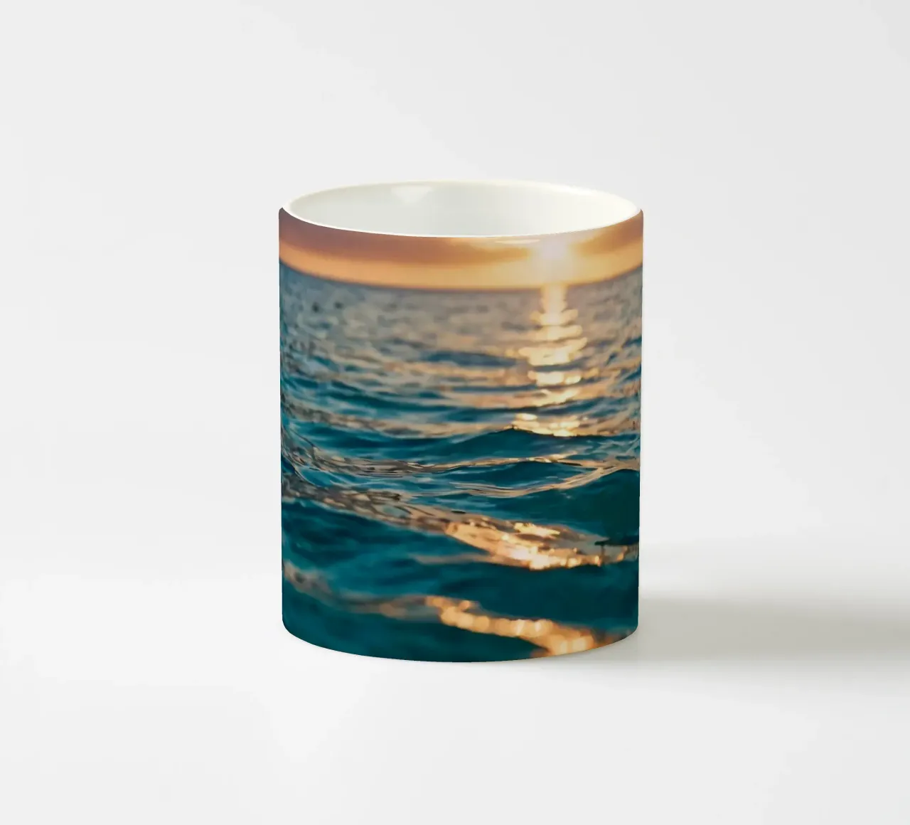 Le calme onde dell'oceano riflettono un tramonto vibrante su un mare calmo. tazza in ceramica da DesignDoodle