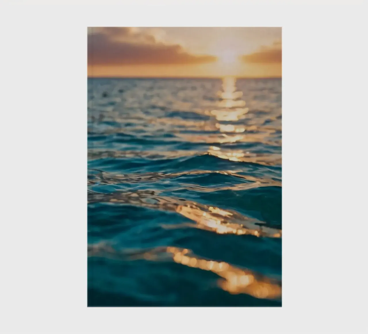 calm ocean waves reflect a vibrant sunset over calm wate notebook by DesignDoodle