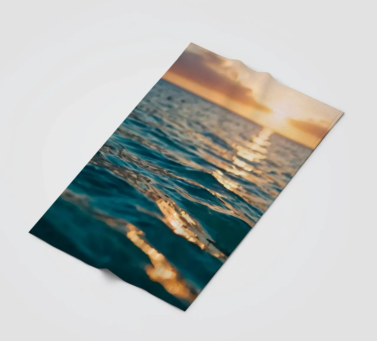 calm ocean waves reflect a vibrant sunset over calm wate fleece blanket by DesignDoodle