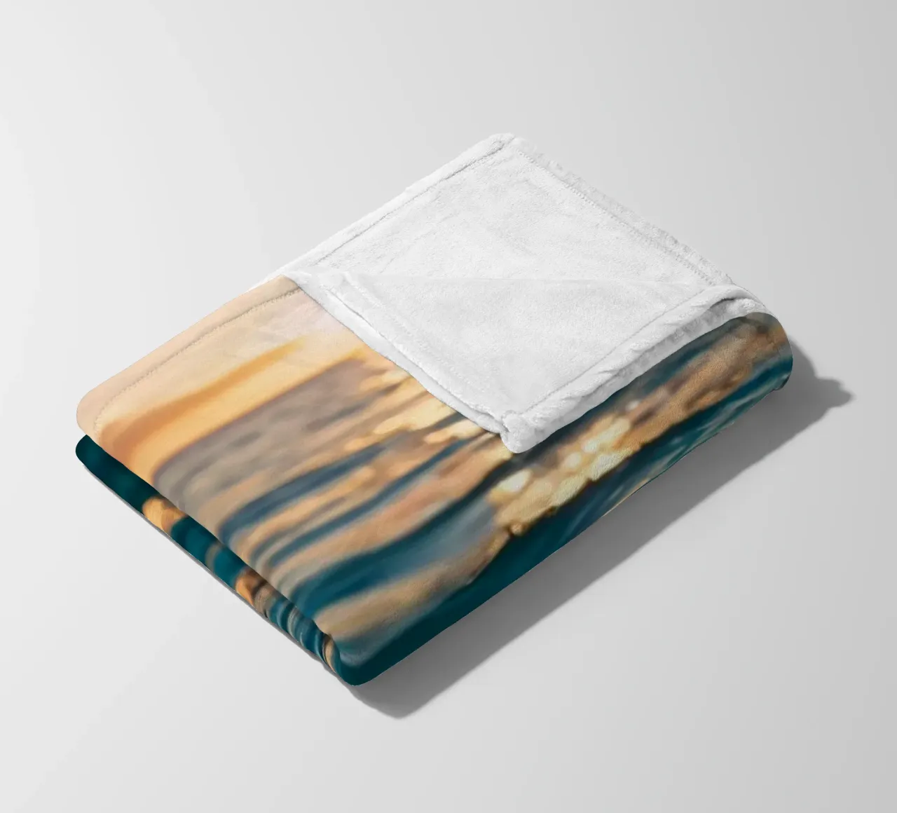 calm ocean waves reflect a vibrant sunset over calm wate fleece blanket by DesignDoodle