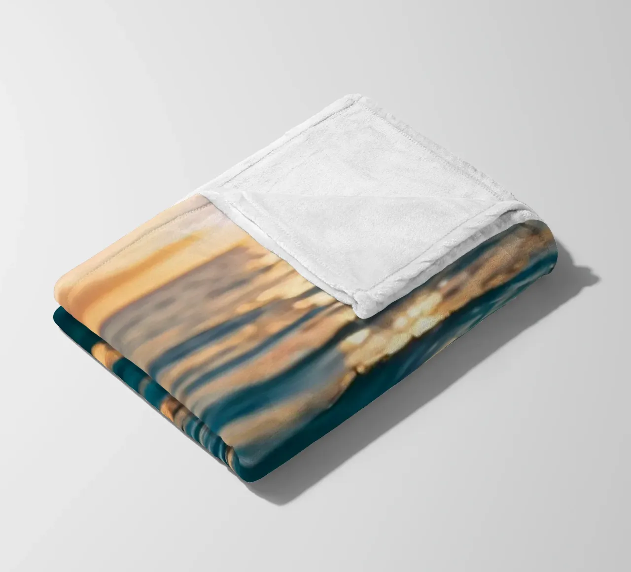 calm ocean waves reflect a vibrant sunset over calm wate fleece blanket by DesignDoodle
