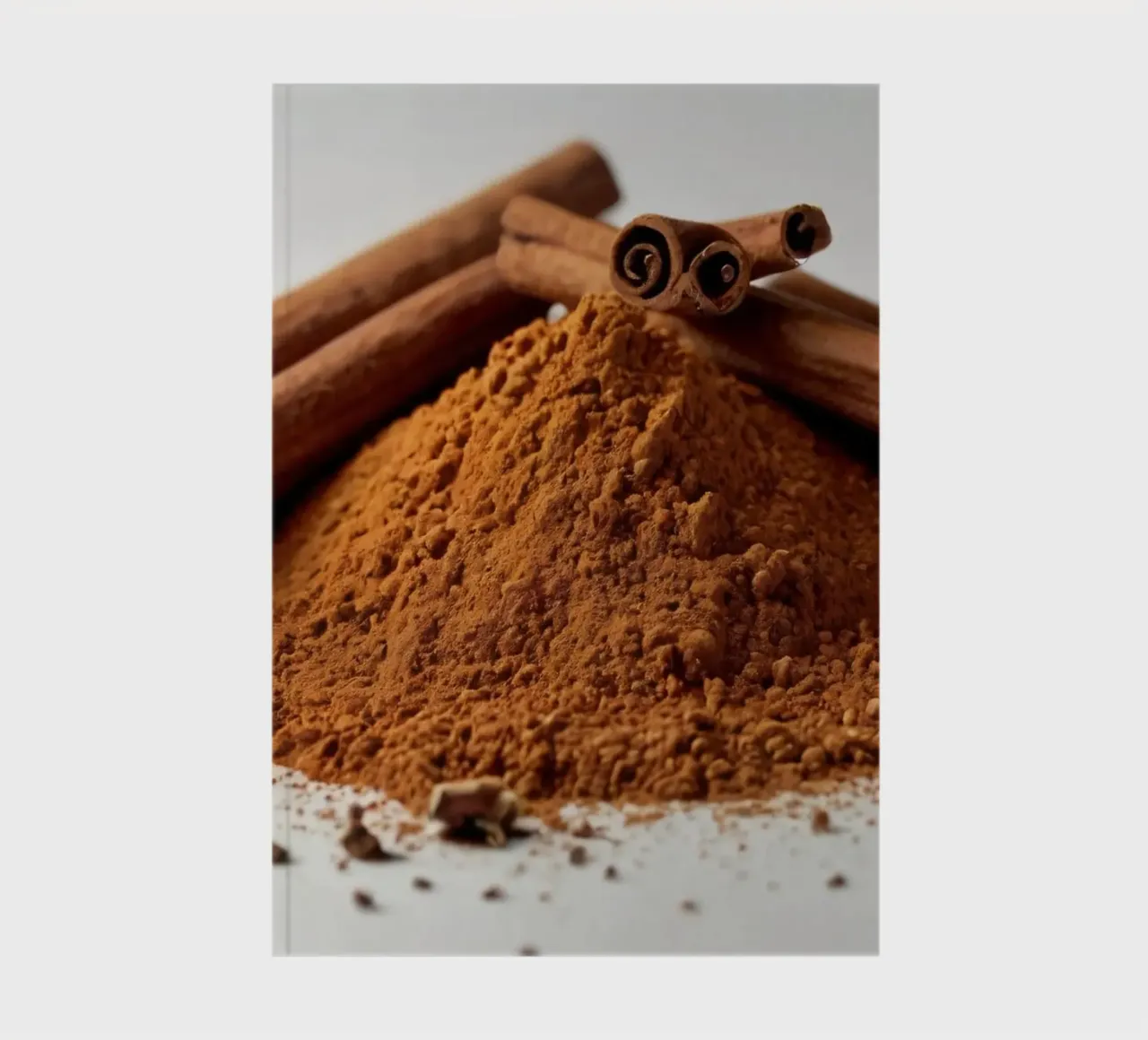 Cinnamon sticks and ground cinnamon pile arranged elegantly notebook by DesignDoodle