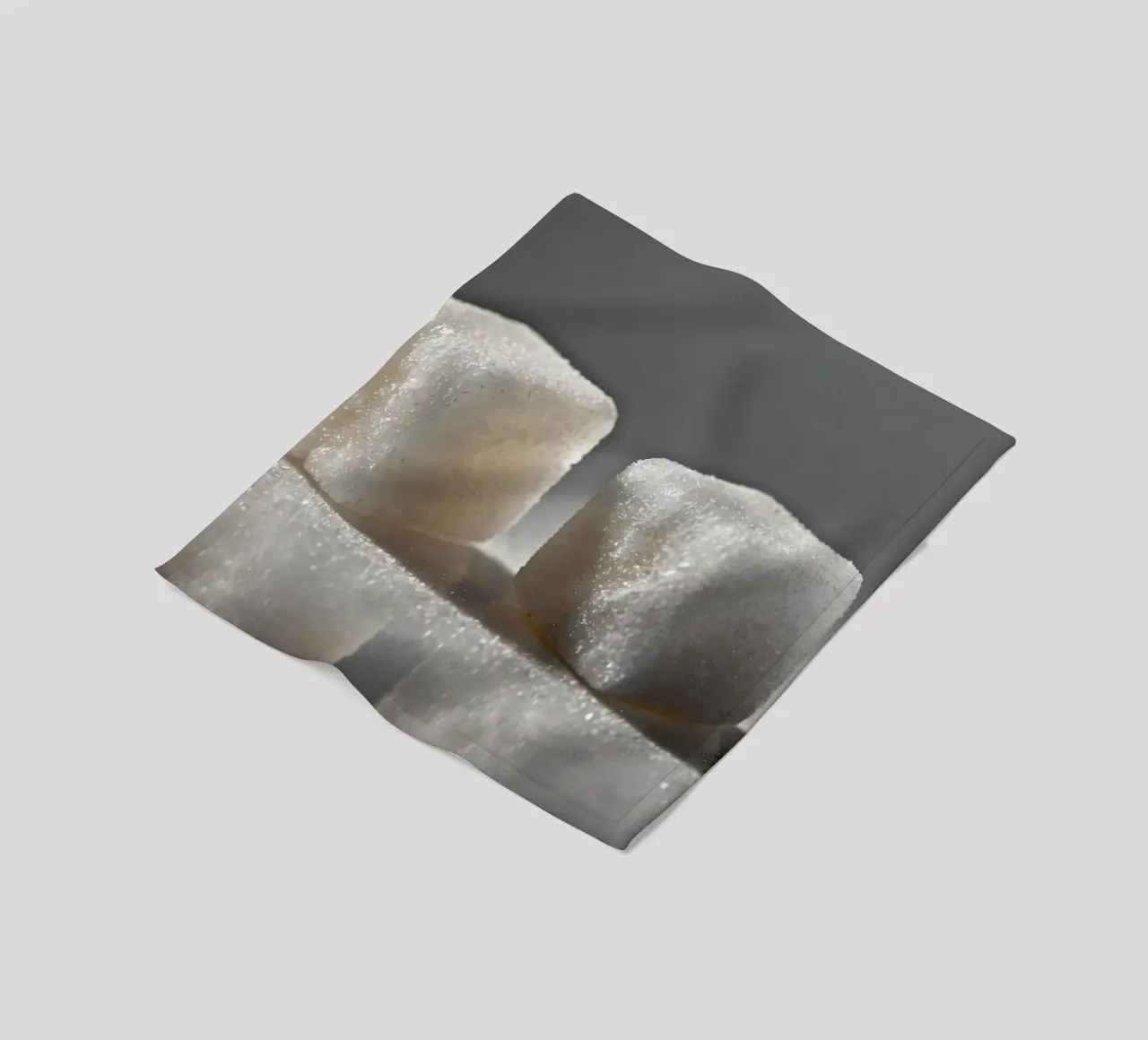Two sugar cubes on a reflective surface with soft lighting fleece blanket by DesignDoodle
