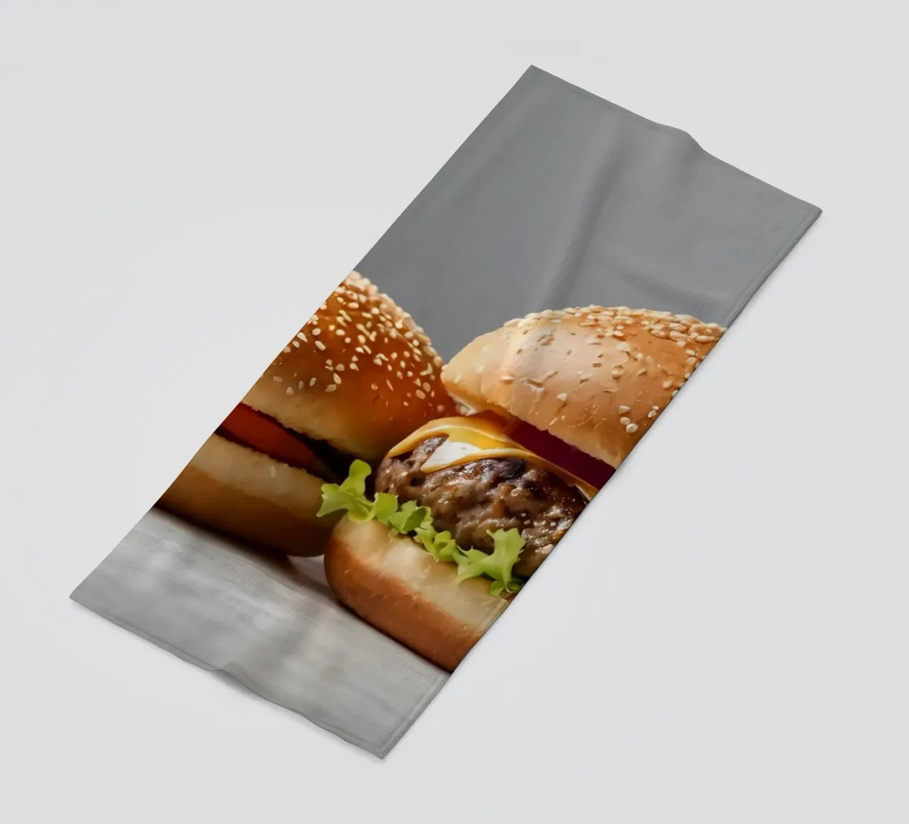 Delizioso cheeseburger e semplice hamburger su un piano di lavoro telo mare da DesignDoodle