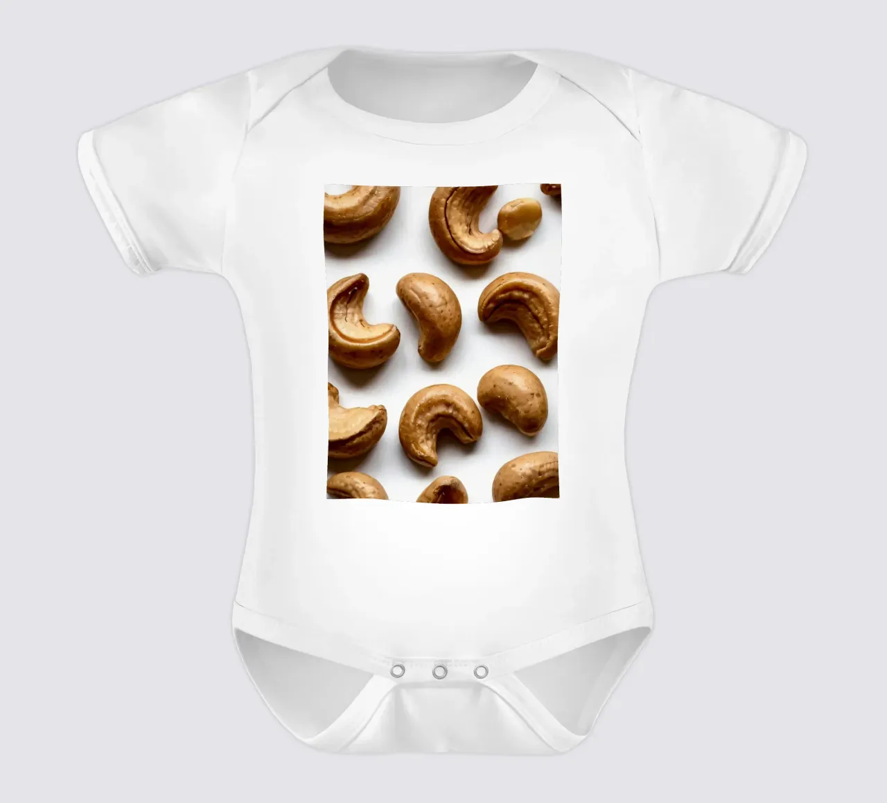 Raw cashew nuts arranged on a white surface for healthy snac short-sleeve baby romper by DesignDoodle
