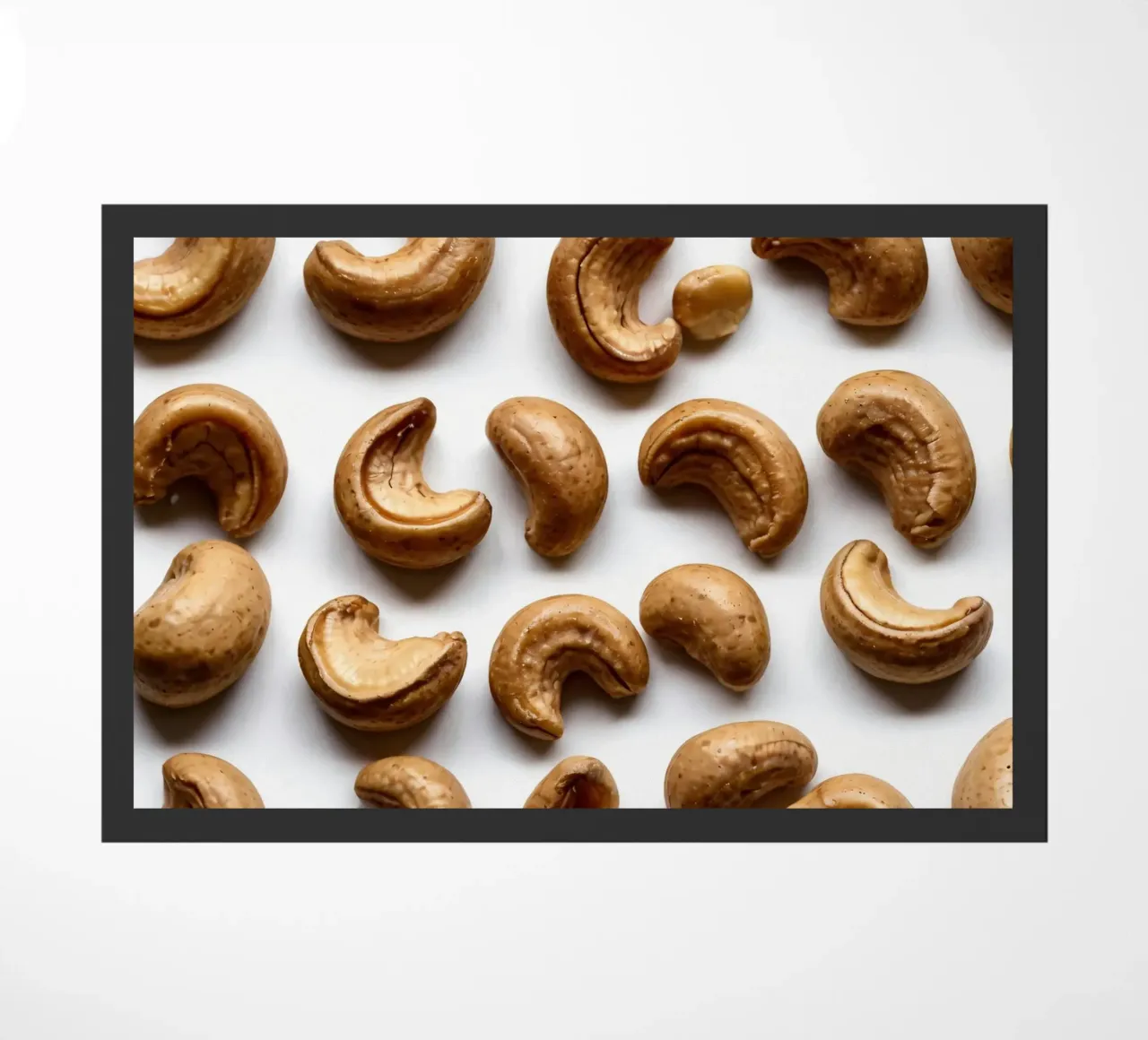 Raw cashew nuts arranged on a white surface for healthy snac doormat by DesignDoodle