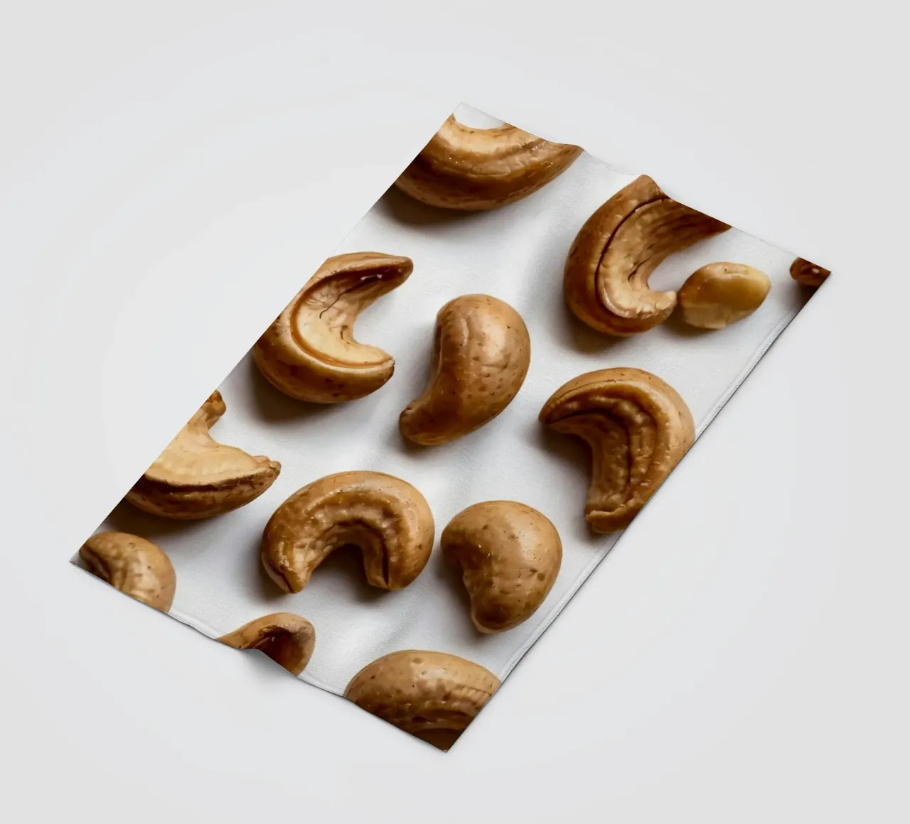 Raw cashew nuts arranged on a white surface for healthy snac fleece blanket by DesignDoodle