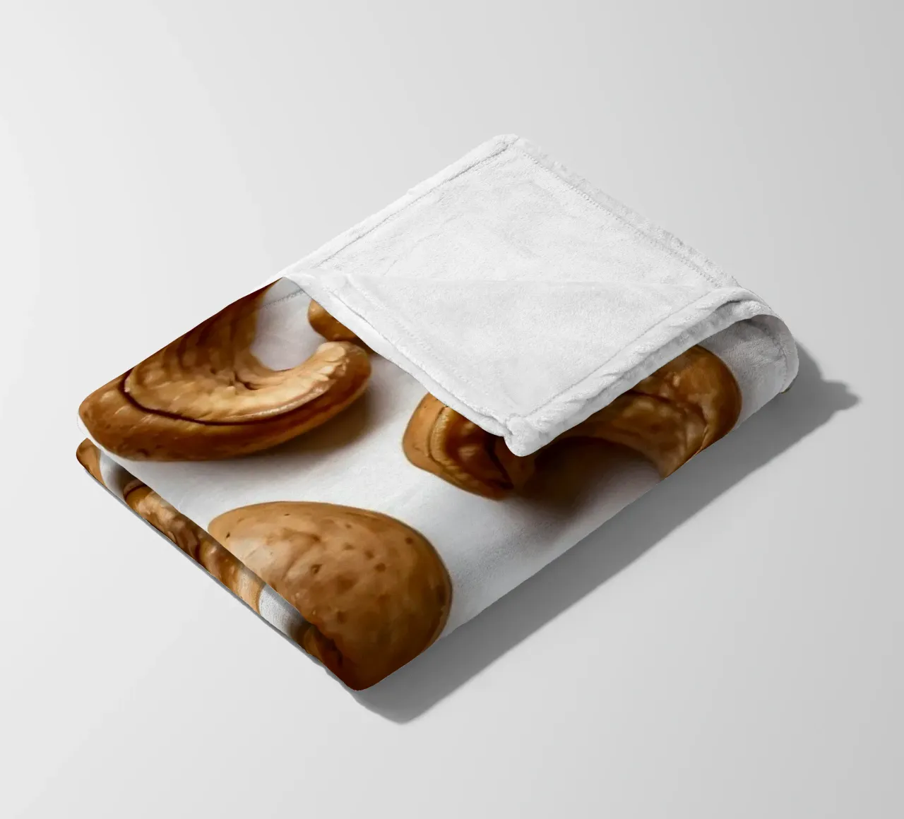 Raw cashew nuts arranged on a white surface for healthy snac fleece blanket by DesignDoodle