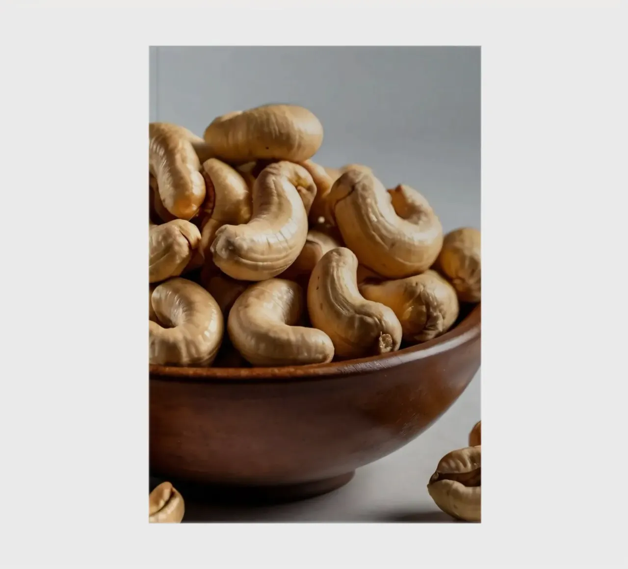 Raw cashew nuts arranged on a white surface for healthy snac notebook by DesignDoodle