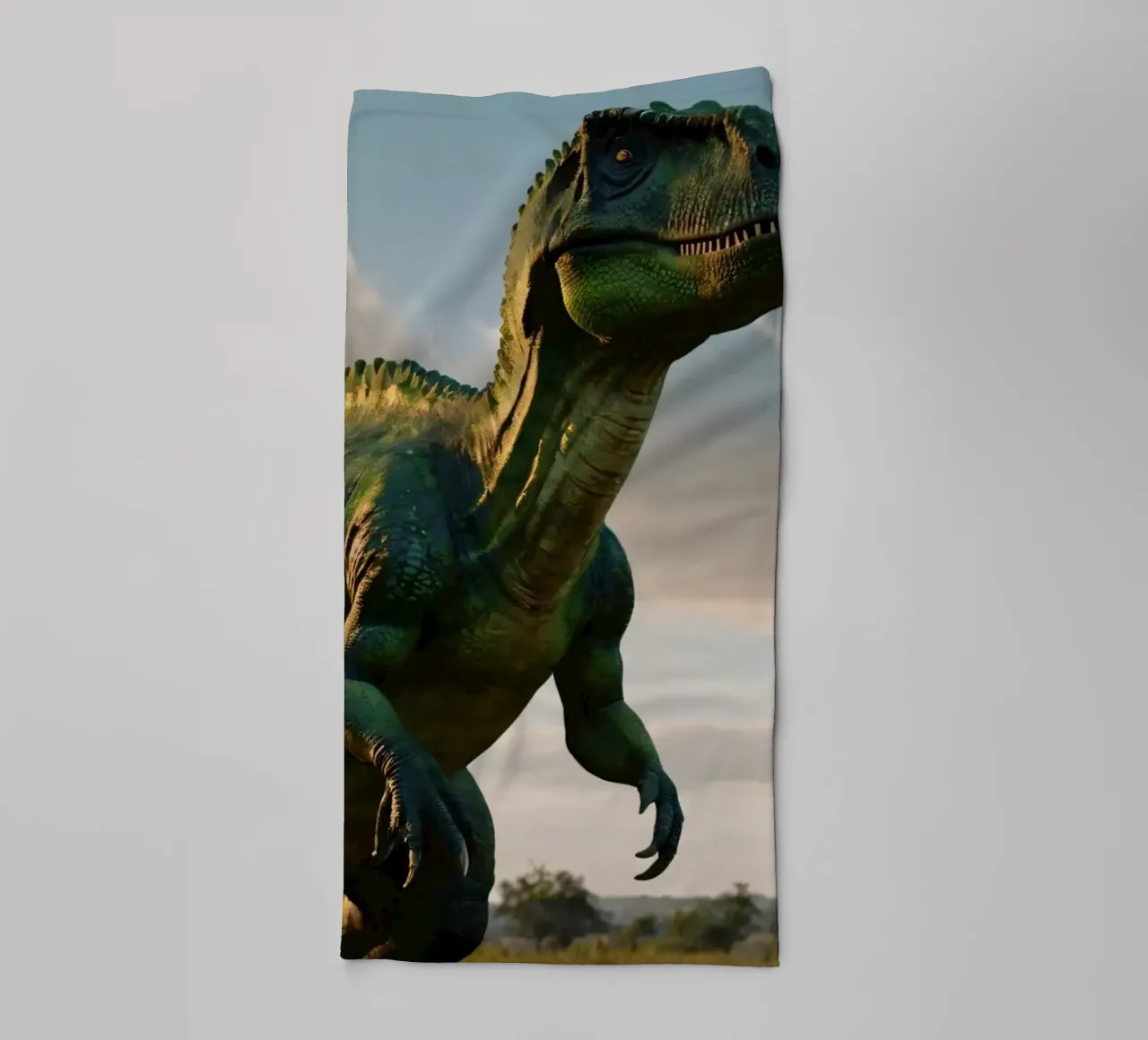 A realistic dinosaur stands in a lush landscape towel by DesignDoodle