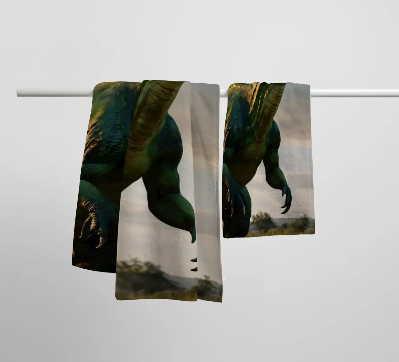 A realistic dinosaur stands in a lush landscape towel by DesignDoodle