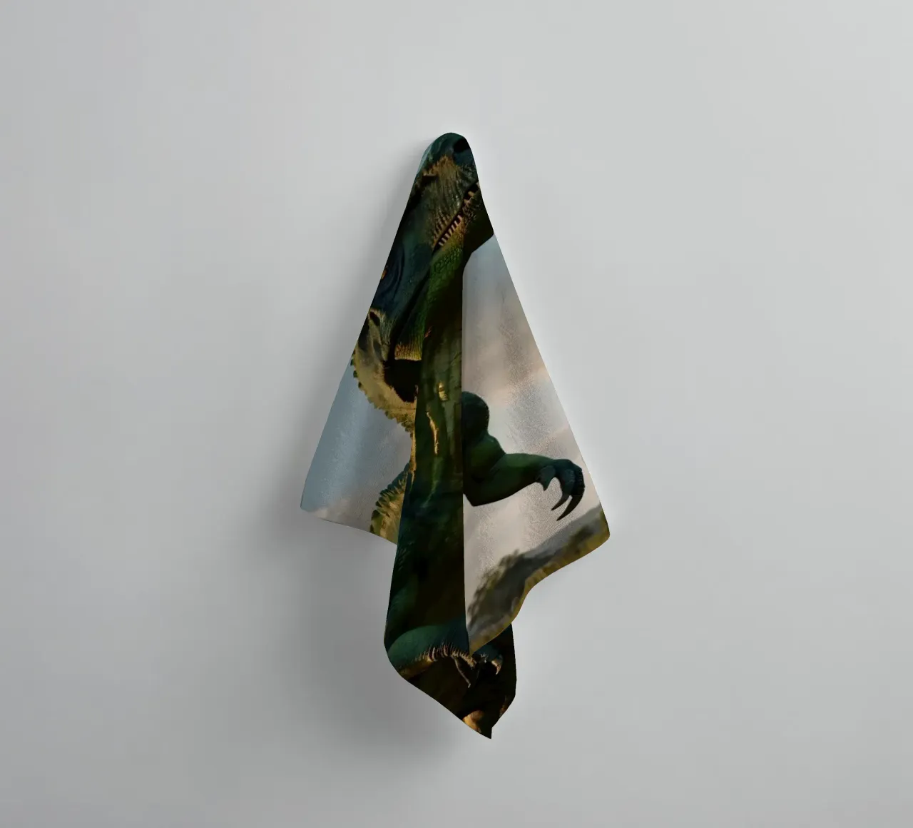 A realistic dinosaur stands in a lush landscape towel by DesignDoodle