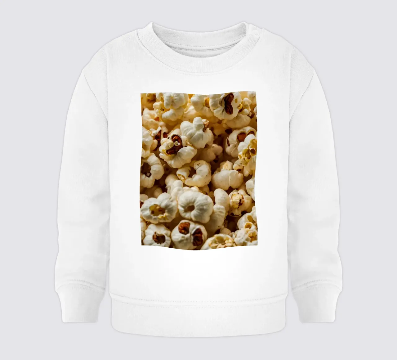 Chicchi di popcorn semplici sparsi in una ciotola, pronti per uno spuntino felpa neonato da DesignDoodle