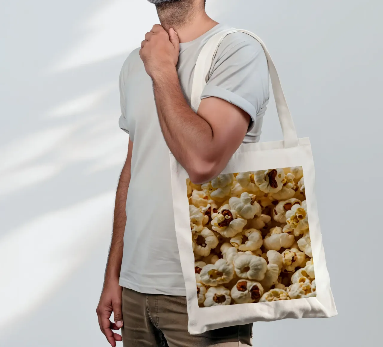 Plain popcorn kernels scattered in a bowl, ready for snackin tote bag by DesignDoodle