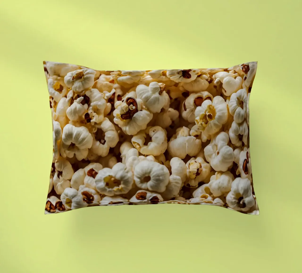 Plain popcorn kernels scattered in a bowl, ready for snackin decorative cushion by DesignDoodle
