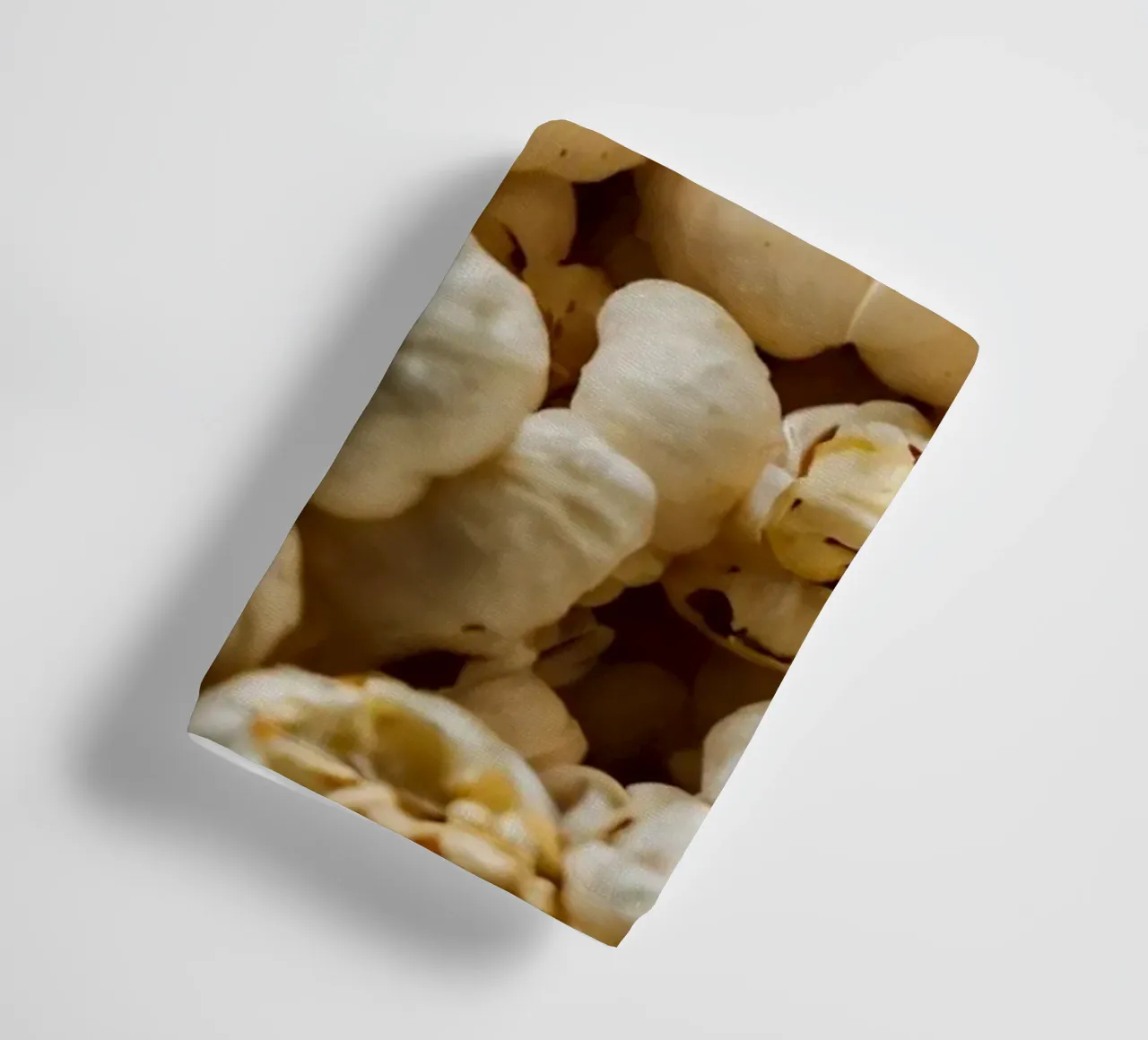 Plain popcorn kernels scattered in a bowl, ready for snackin towel by DesignDoodle