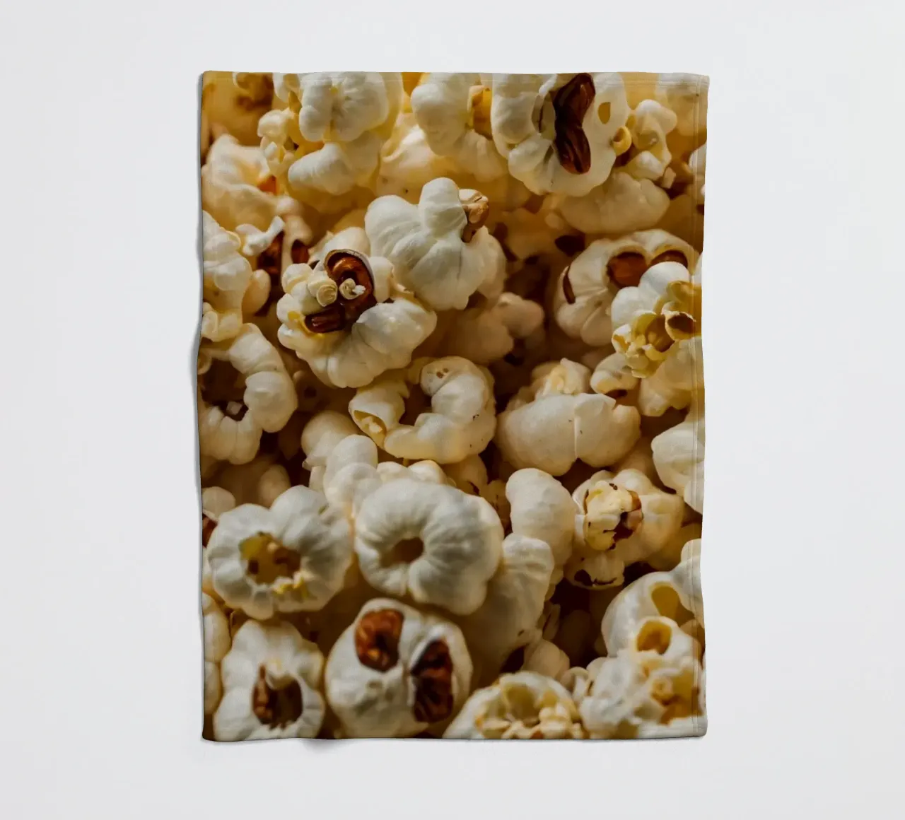 Plain popcorn kernels scattered in a bowl, ready for snackin fleece blanket by DesignDoodle