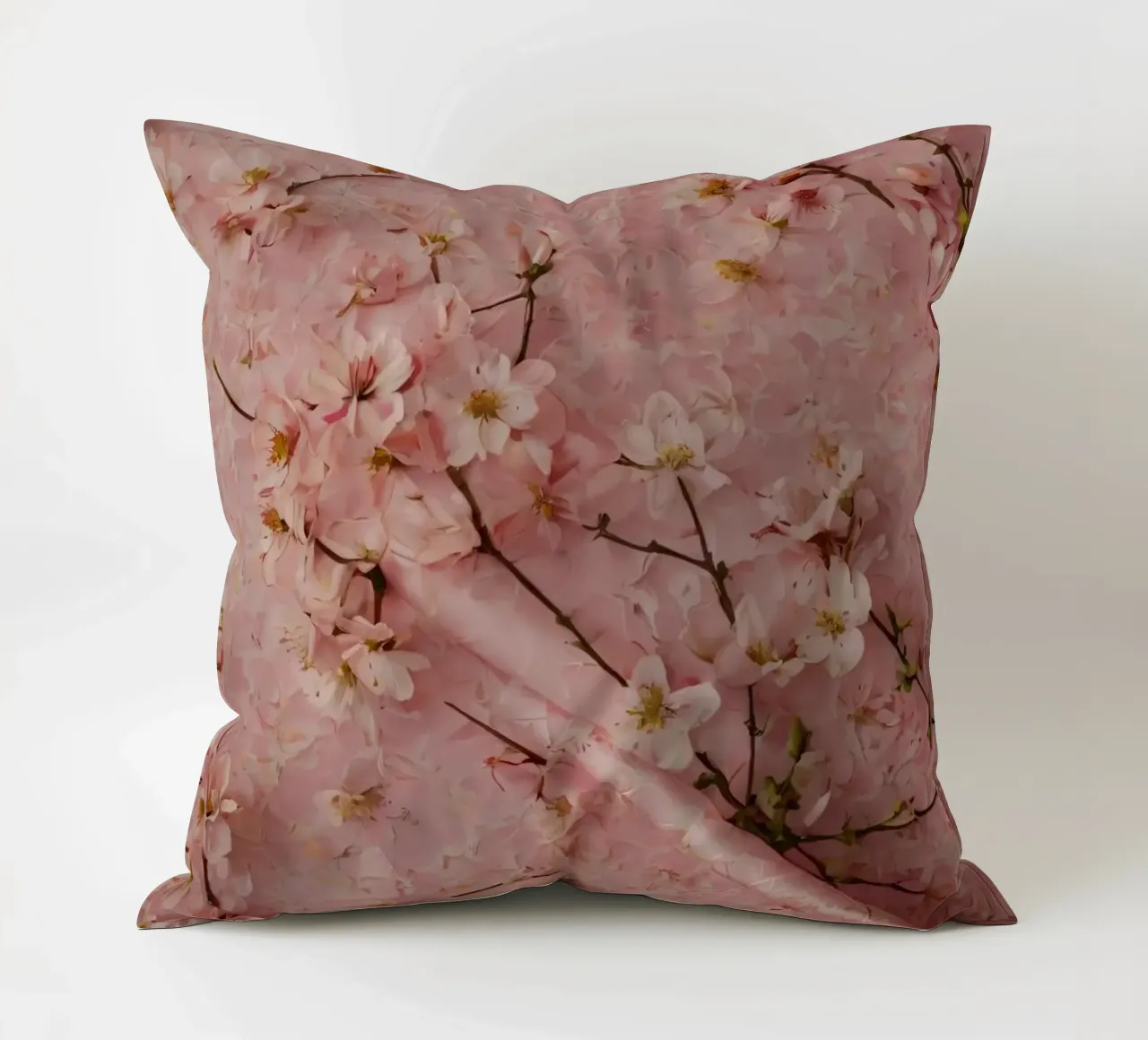 Delicati fiori di ciliegio rosa disposti su un tappeto rosa tenue cuscino da DesignDoodle