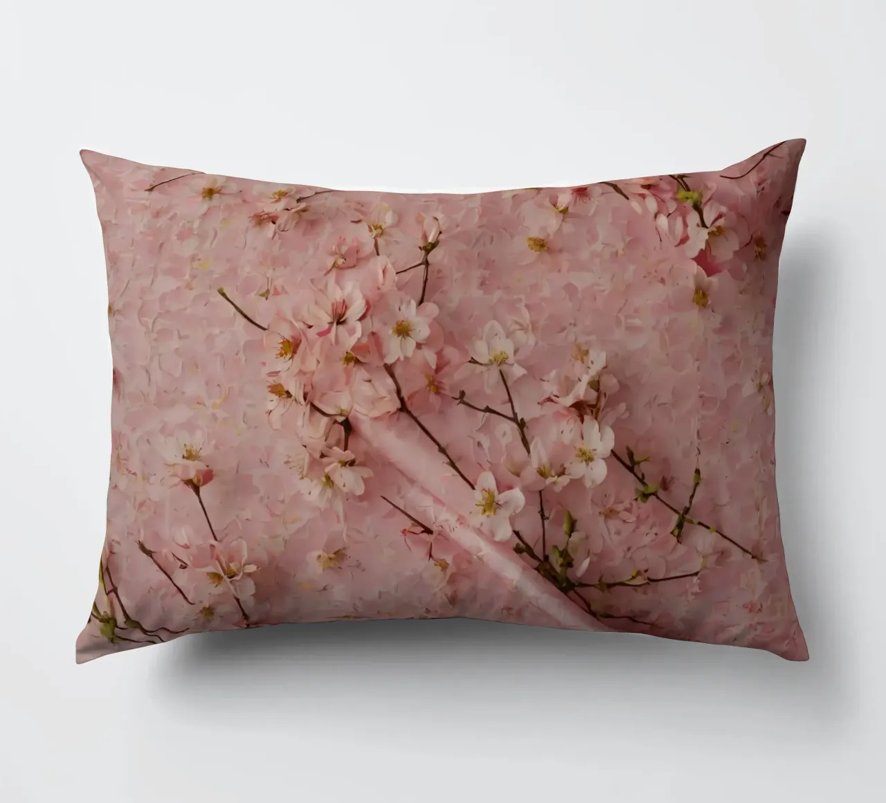 Delicati fiori di ciliegio rosa disposti su un tappeto rosa tenue cuscino da DesignDoodle