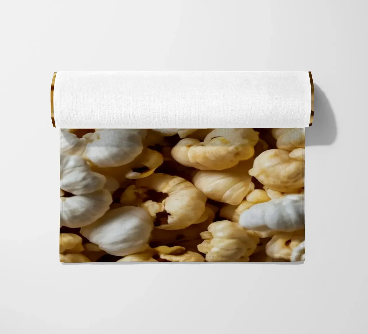 Freshly popped popcorn in a close-up view beach towel by DesignDoodle