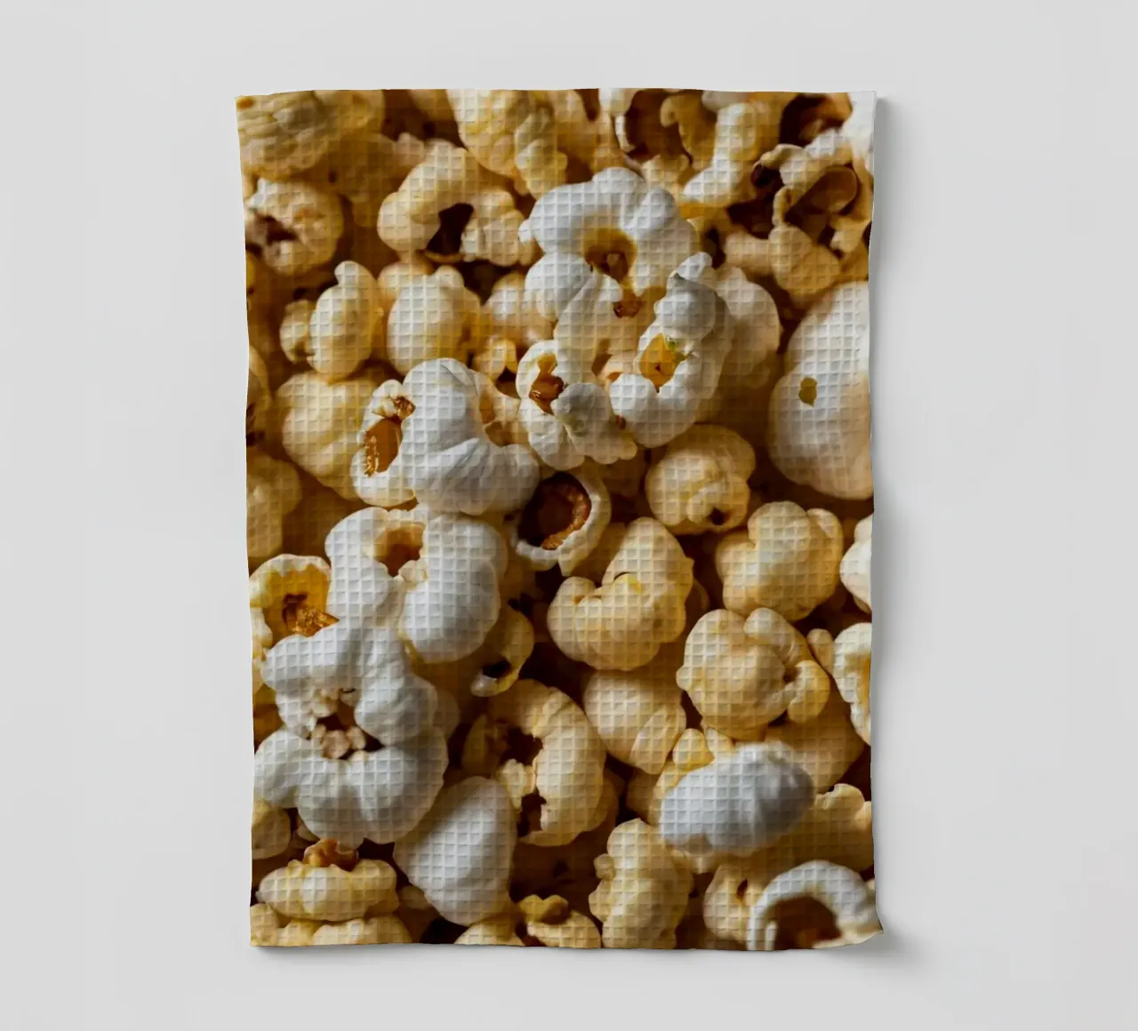 Freshly popped popcorn in a close-up view tea towel by DesignDoodle