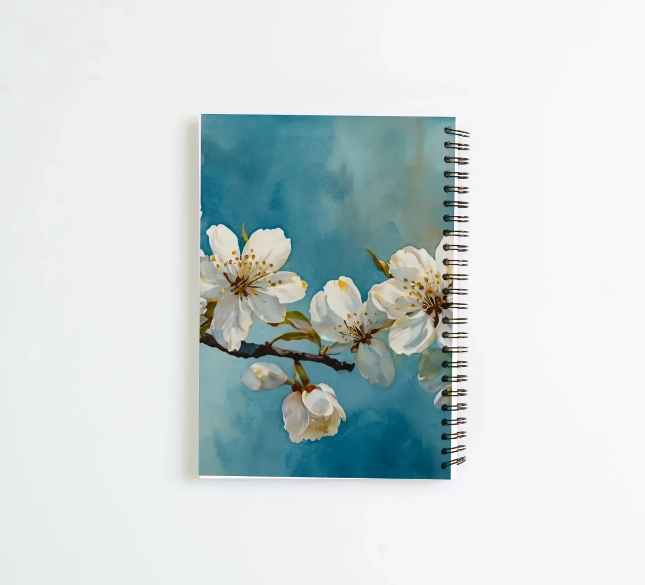 Blossoming cherry tree branch adorned with delicate white spiral notebook by DesignDoodle