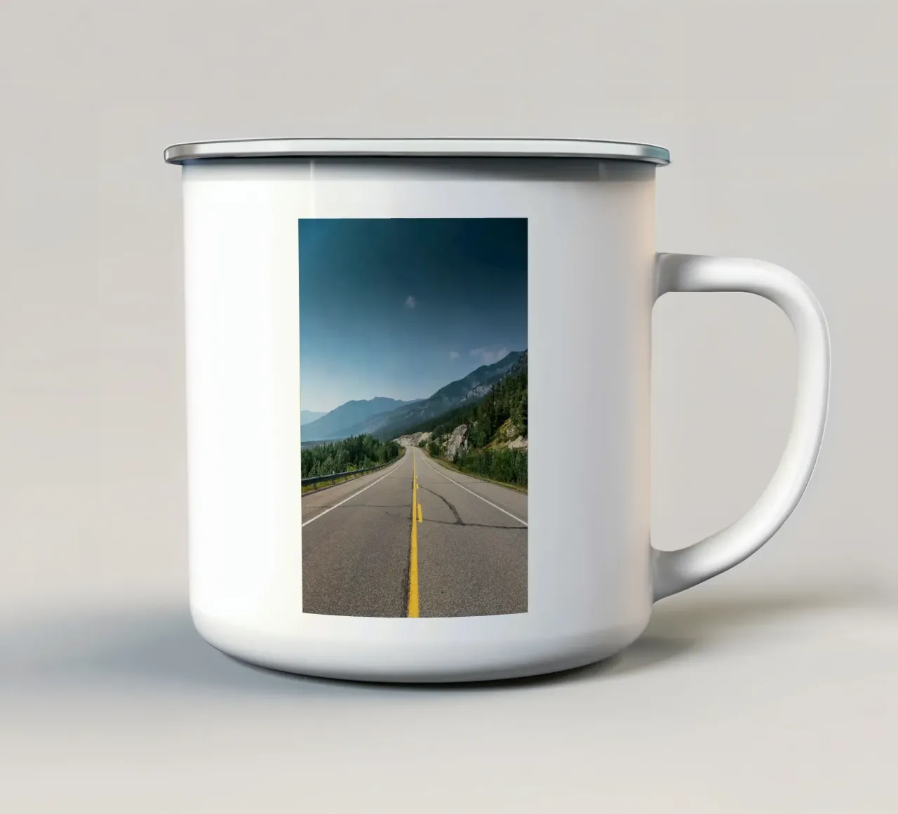 road highway mountains forest trees sky clouds pavement enamel mug by minerva santiago