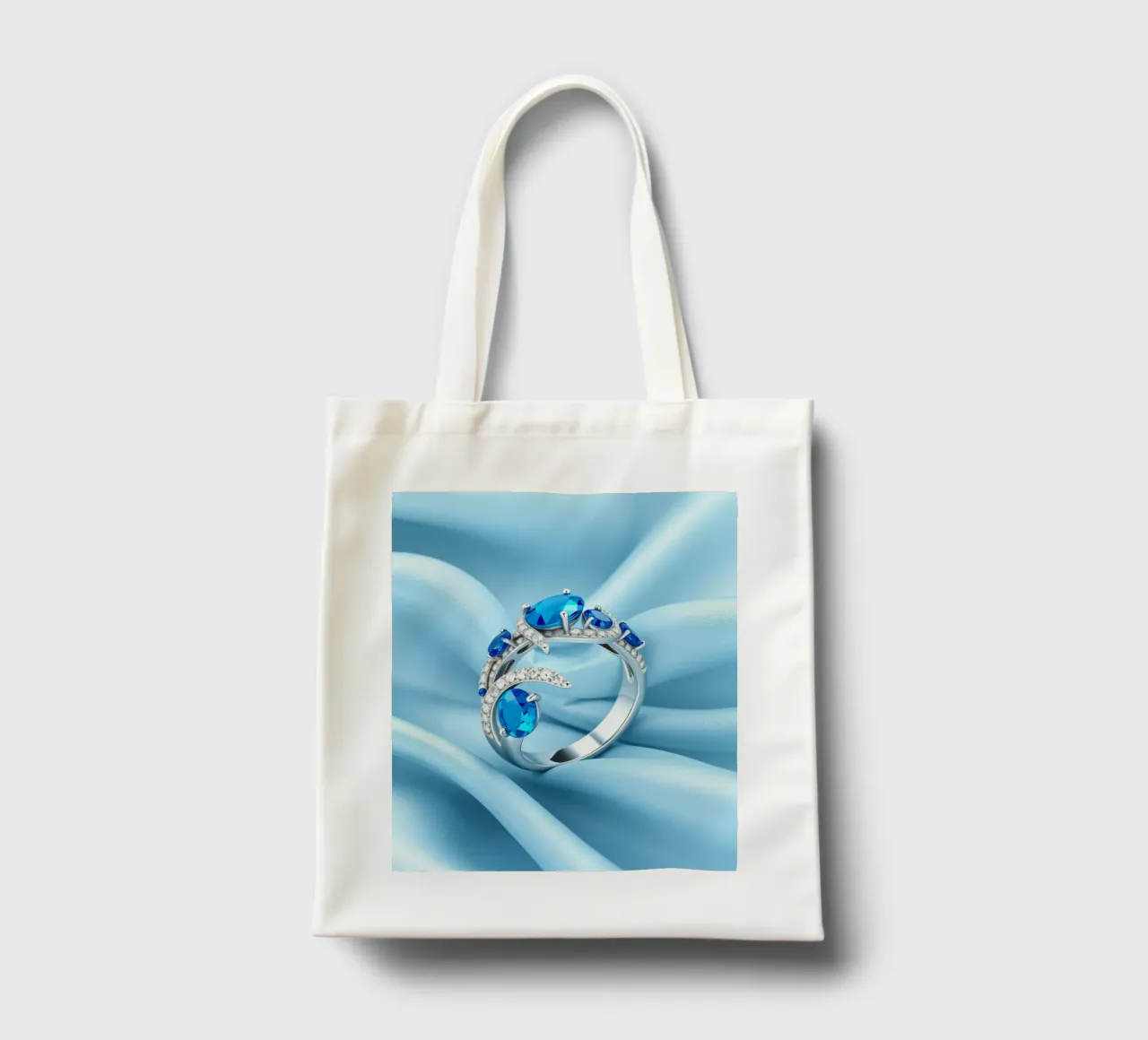 Elegante anello con gemma blu esposto in morbido tessuto di seta blu borsa in juta da DesignDoodle
