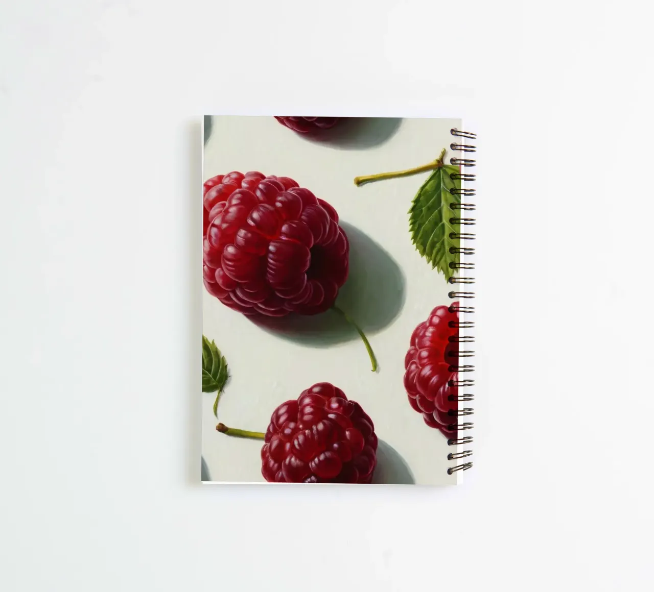 Freshly picked raspberries scattered on a light background spiral notebook by DesignDoodle