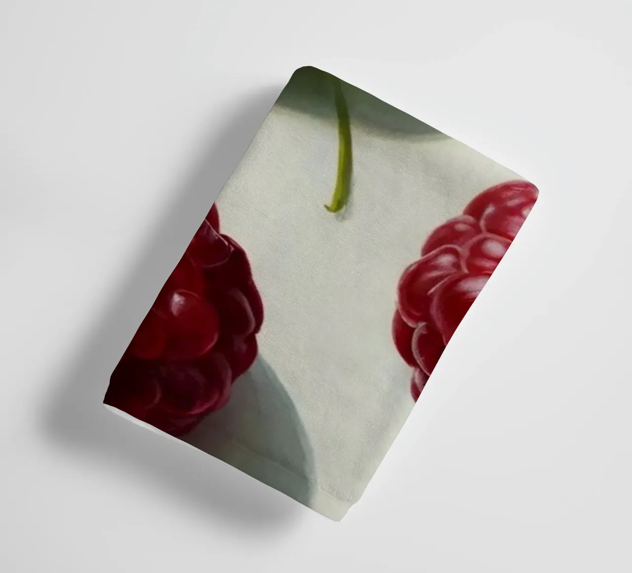 Freshly picked raspberries scattered on a light background towel by DesignDoodle