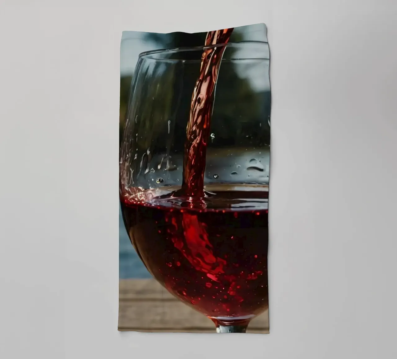 Pouring red wine into a glass beside a tranquil lake at suns towel by DesignDoodle