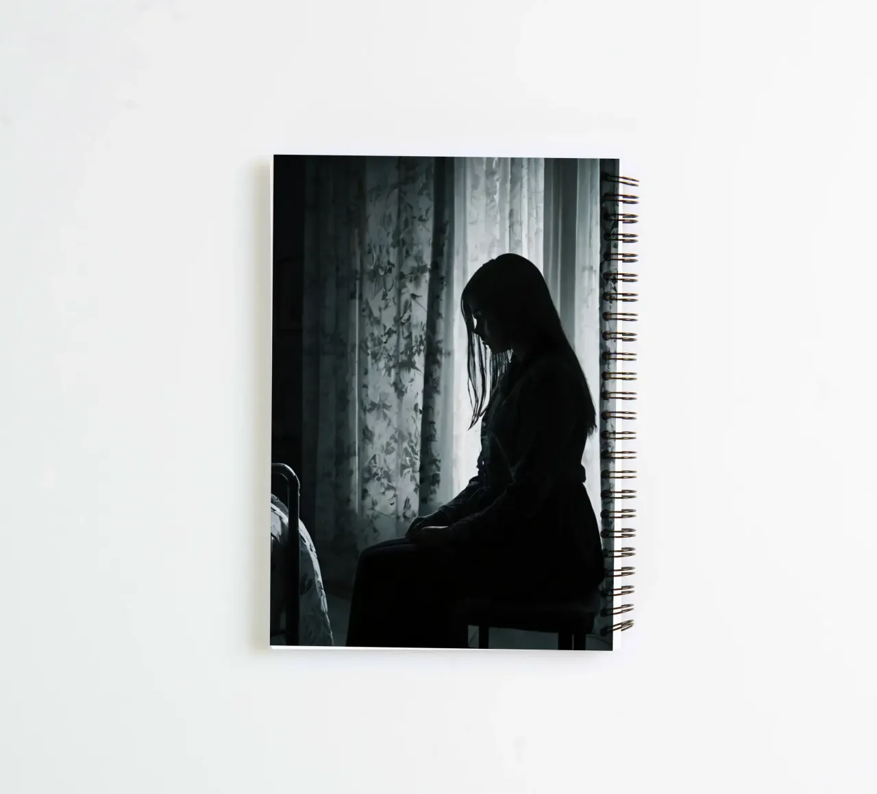 A girl sits silently in a dimly lit room, contemplating life spiral notebook by DesignDoodle