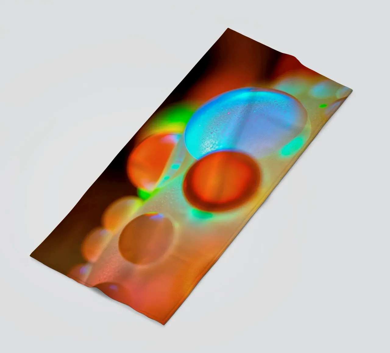 Colorful abstract design with illuminated bubbles beach towel by DesignDoodle