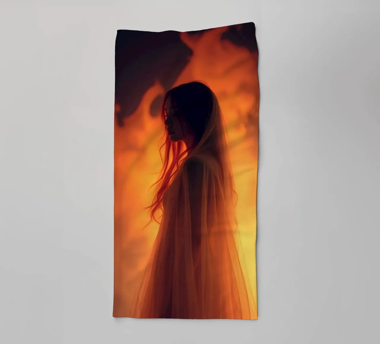 Elegant silhouette stands against a fiery background towel by DesignDoodle