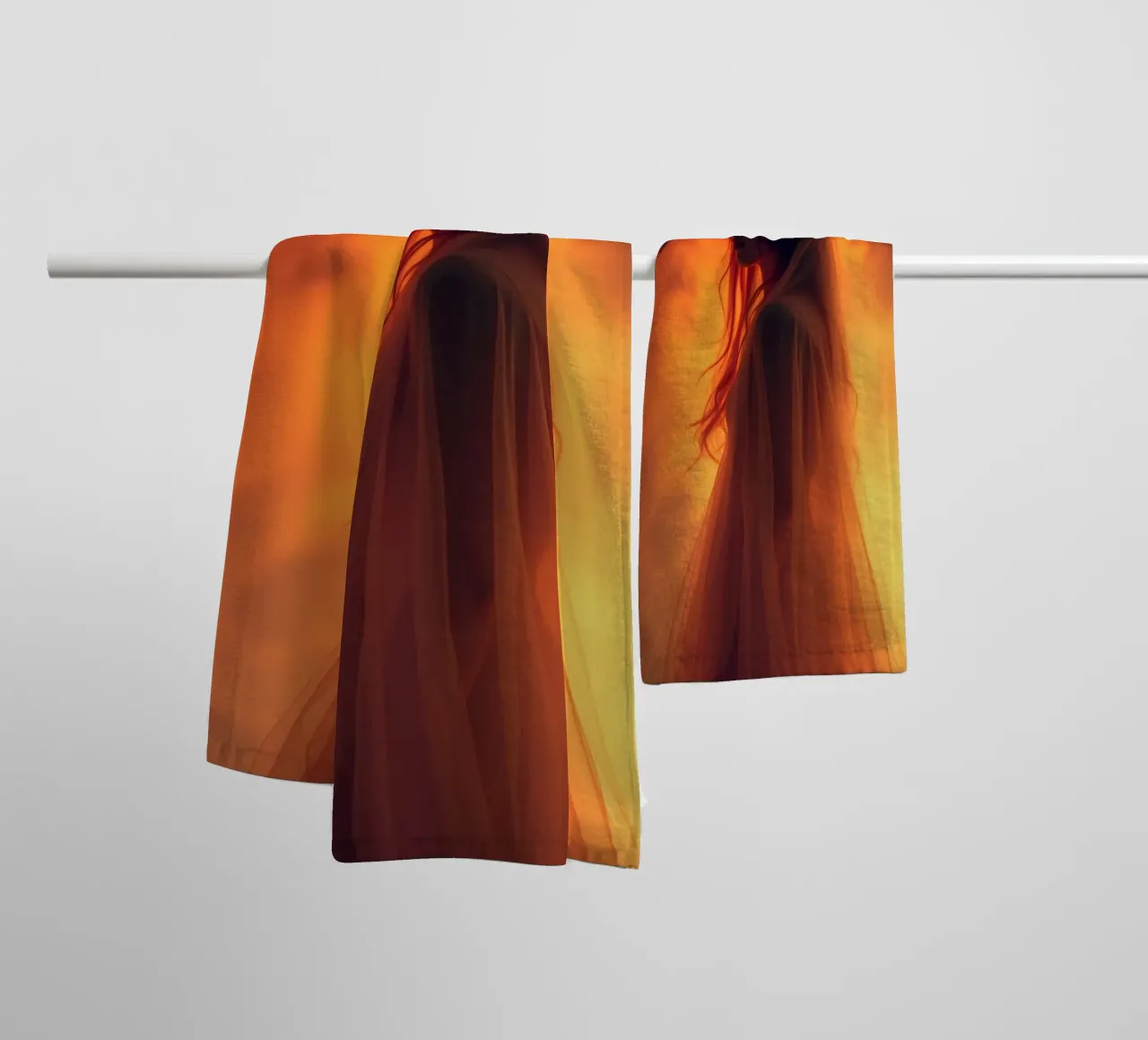 Elegant silhouette stands against a fiery background towel by DesignDoodle
