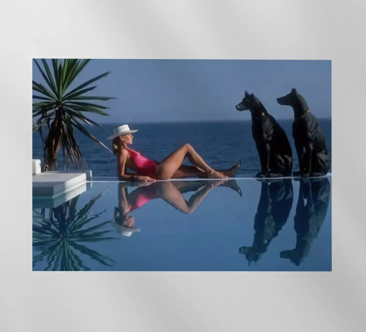 Slim Aarons - Bikini a bordo piscina e due cani neri pellicola backlit da The Poster UK