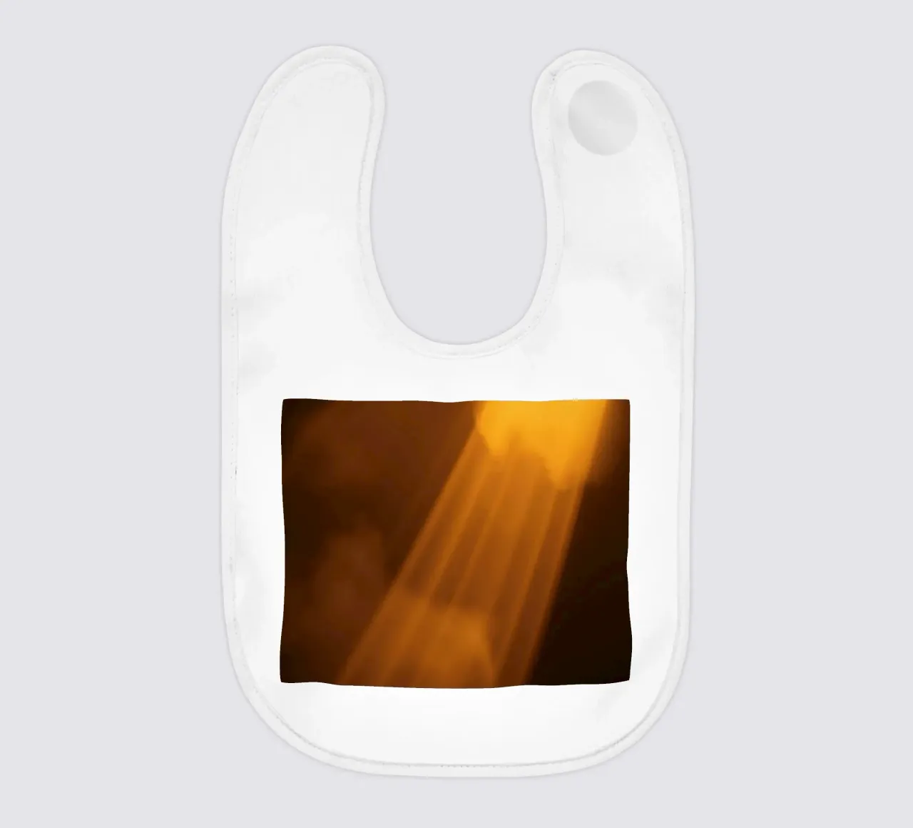 Abstract warm light rays filtering through a dark space baby bib by DesignDoodle
