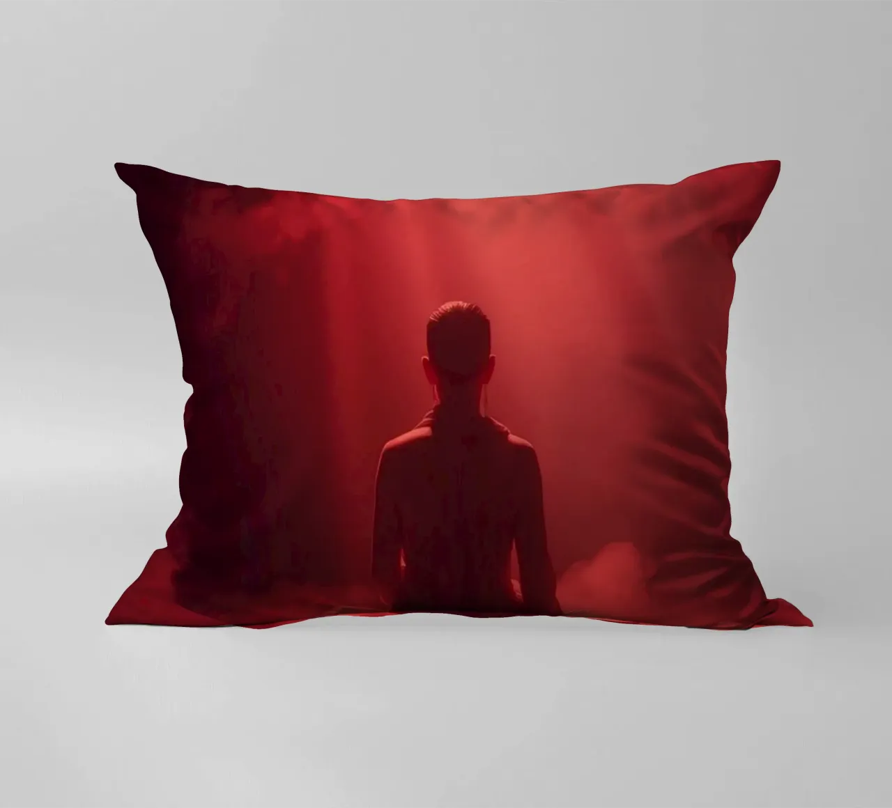 Captivating red light envelops a man sitting on a box in fog decorative cushion by DesignDoodle
