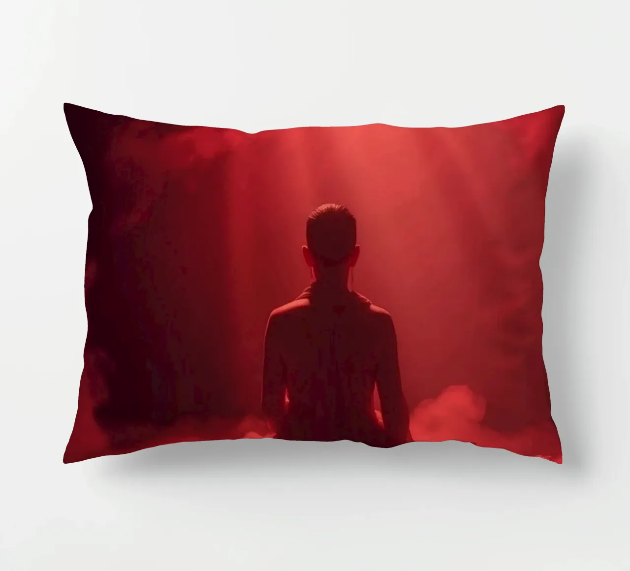 Captivating red light envelops a man sitting on a box in fog decorative cushion by DesignDoodle