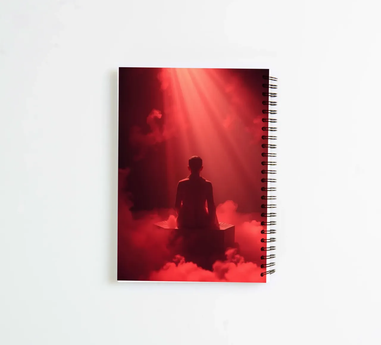 Captivating red light envelops a man sitting on a box in fog spiral notebook by DesignDoodle