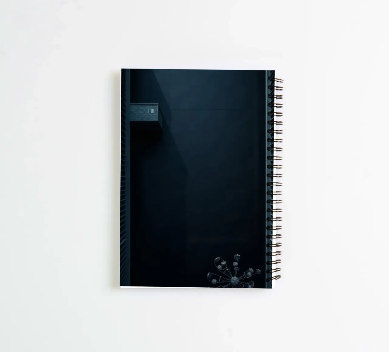 Elegant dark background featuring a minimalist chandelier spiral notebook by DesignDoodle