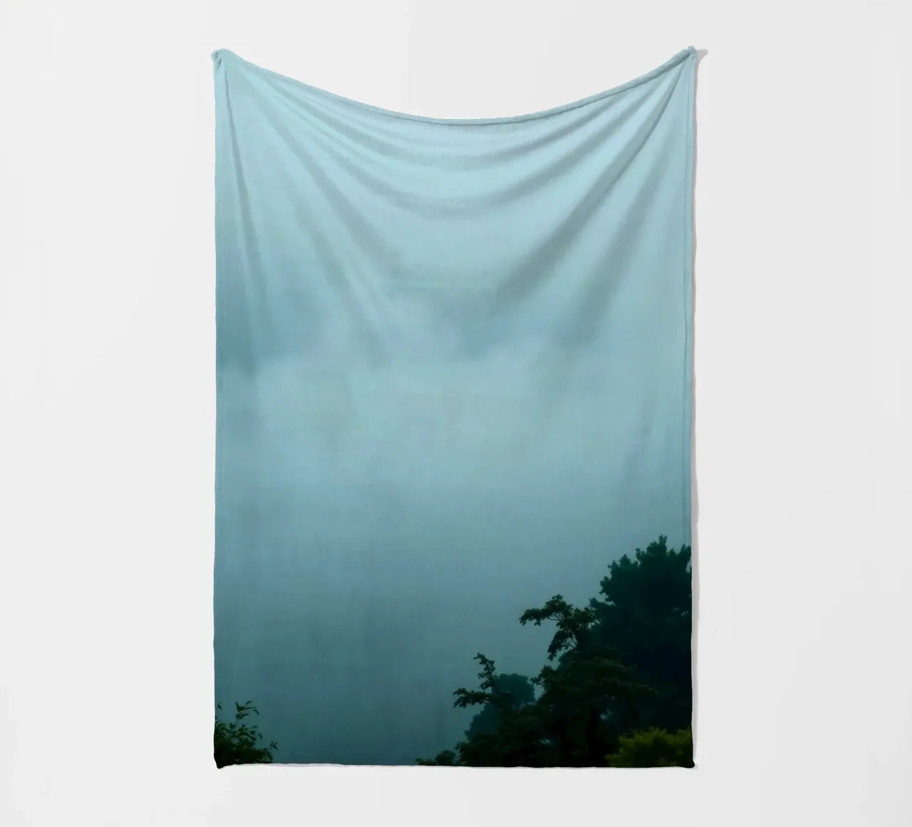 Foggy landscape with trees, creating calming atmosphere fleece blanket by DesignDoodle