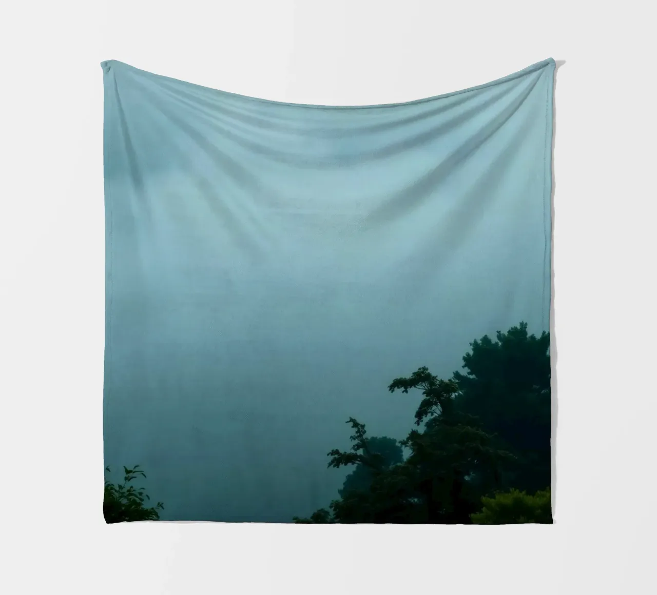 Foggy landscape with trees, creating calming atmosphere fleece blanket by DesignDoodle