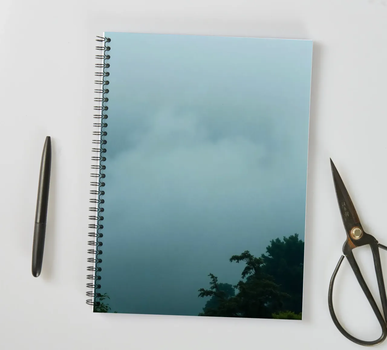 Foggy landscape with trees, creating calming atmosphere spiral notebook by DesignDoodle
